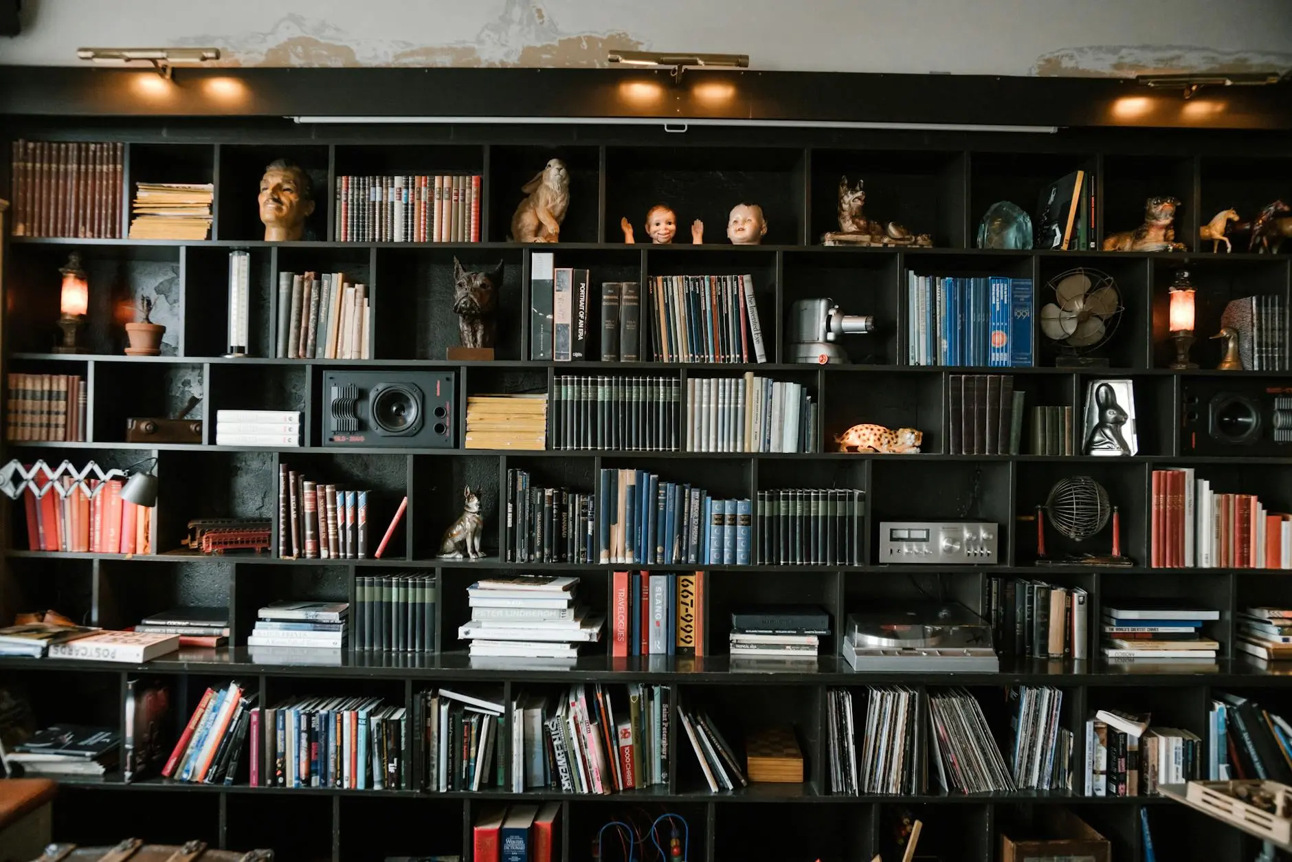 Richly decorated bookshelf filled with books, artifacts, and collectible decor